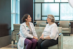 Two women talking. Links to Beneficiary Designations