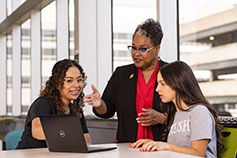 A professor with two students. Links to Irrevocable Pledge