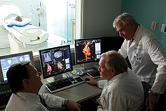 Medical professionals looking at body scan. Link to Gifts from Retirement Plans